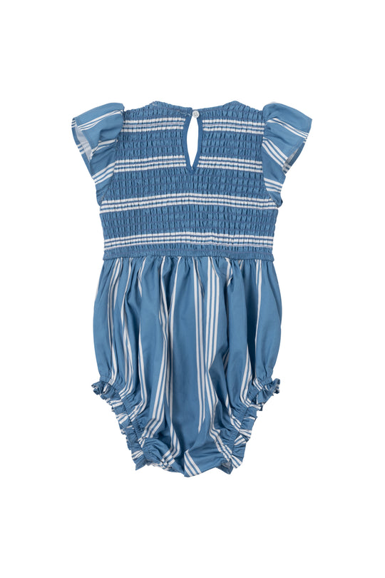 The Ivy City Co Baby Adelaide Romper in Blue features white horizontal and vertical stripes, short ruffled sleeves, a smocked bodice, and ruffled leg openings, shown on a white background.