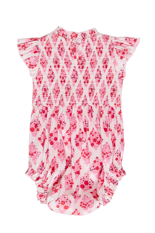 Baby romper with pink and white pattern on a white background