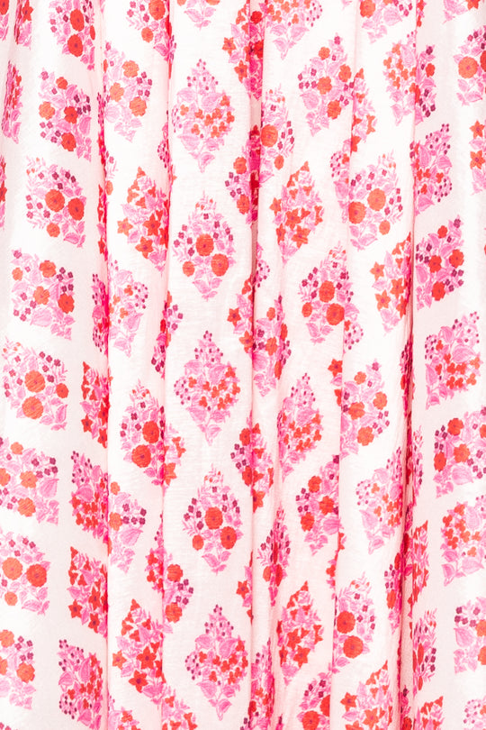 Patterned fabric with pink and red floral design on a white background