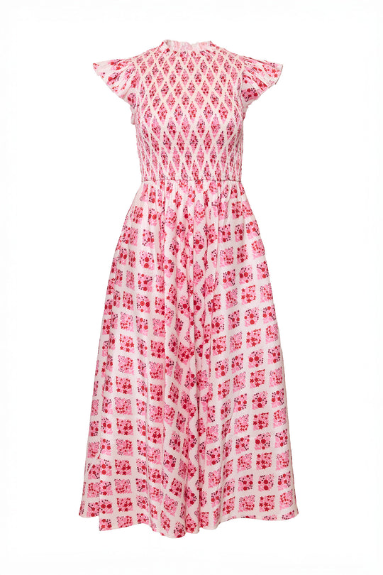 Pink and white patterned dress on a white background