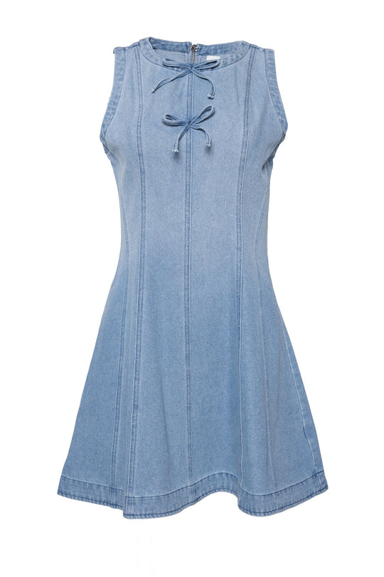 The Austin Dress in Light Wash Denim by Ivy City Co is a sleeveless mini dress featuring a flared skirt, vertical stitching details, and a tie at the neckline. Made from stretch denim for added comfort, the dress is showcased against a white background.