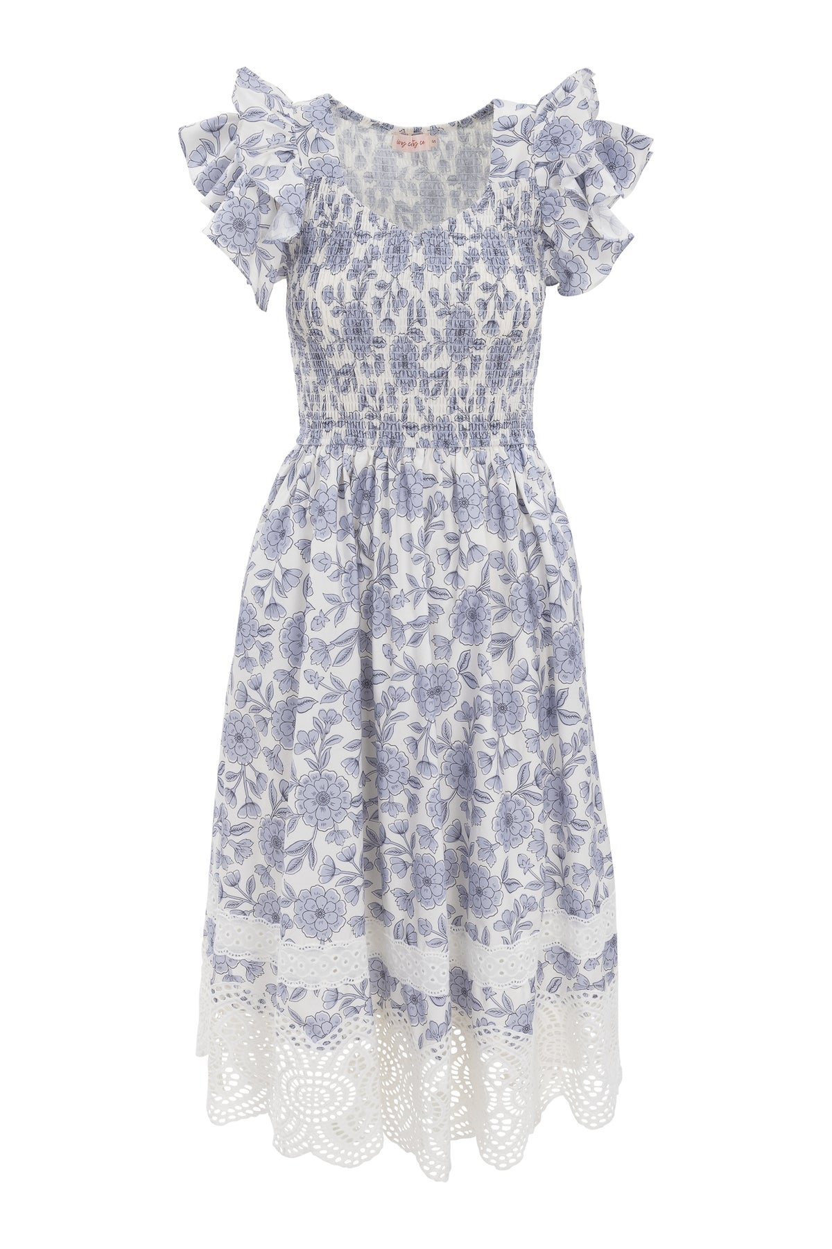 The Hattie Dress in Blue Floral by Ivy City Co is a white cotton midi dress with short ruffled sleeves, a shirred bodice, blue floral print, and an intricately laced hem—perfect for any occasion.