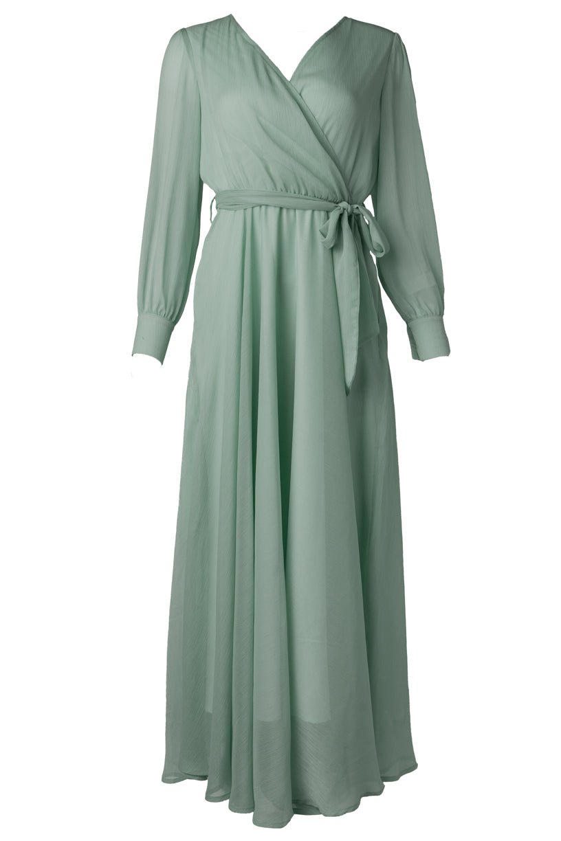 The Andie Dress in Sage by Ivy City Co is a long, light green maxi dress featuring long sleeves, a V-neckline, and a matching fabric belt at the waist—ideal for an elegant bridesmaid look or as a comfortable maternity wedding guest dress.