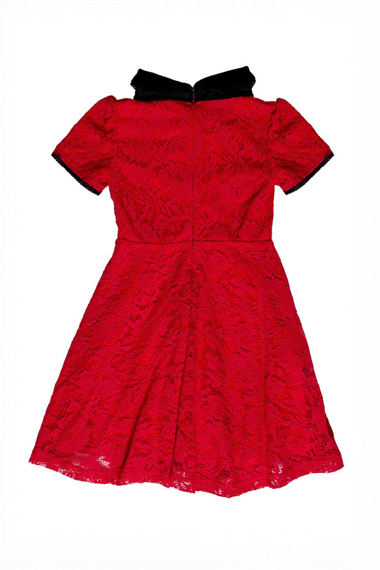 The Mini Penny Dress in Red Lace by Ivy City Co features short sleeves, a knee-length silhouette, and elegant black accents on the collar and sleeve trim. Shown laid flat on a white background, this dress is perfect for any special occasion.
