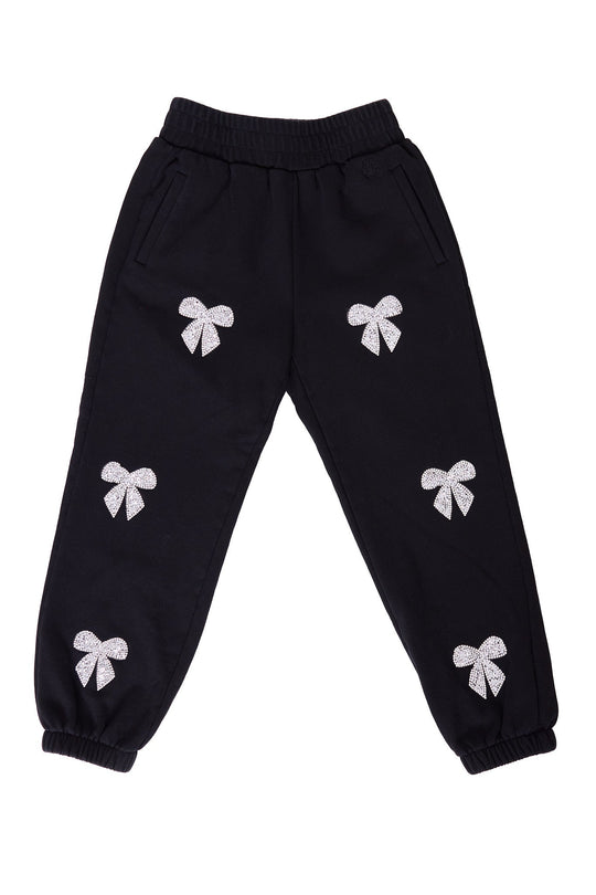 The Mini Micah Jogger Sweatpants in Black by Ivy City Co feature an elastic waistband and cuffs, and are adorned with six white glittery bow designs on the front, adding a playful sparkle to these girls’ cotton joggers.