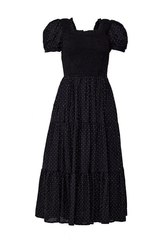 The Darby Dress in Black Diamonte by Ivy City Co is an ankle-length maternity-friendly dress featuring short puff sleeves, a smocked bodice, and a tiered skirt adorned with a subtle dotted pattern for an effortlessly elegant look.