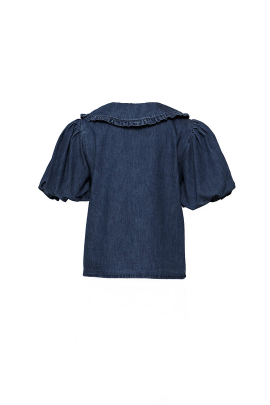 Back view of the Andrea Blouse in Denim with Velvet Tie by Ivy City Co, featuring short puffed sleeves, a ruffled collar, and a nursing-friendly design for effortless style.