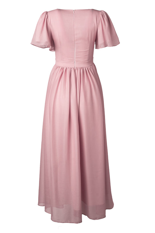 The Abbie Dress in Blush by Ivy City Co features short flutter sleeves, a fitted waist, flowing skirt, and back zipper. Its lightweight, slightly sheer fabric creates a soft, elegant look—perfect as a modest bridesmaid dress.