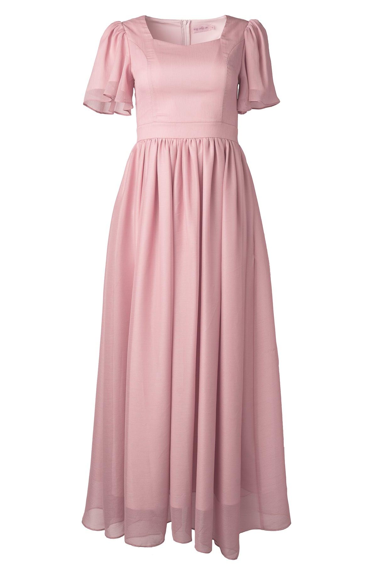 The Abbie Dress in Blush by Ivy City Co features short flutter sleeves, a fitted bodice, and a flowing gathered skirt. Made from lightweight, semi-sheer fabric, this modest maxi dress is perfect for bridesmaids seeking an elegant look.