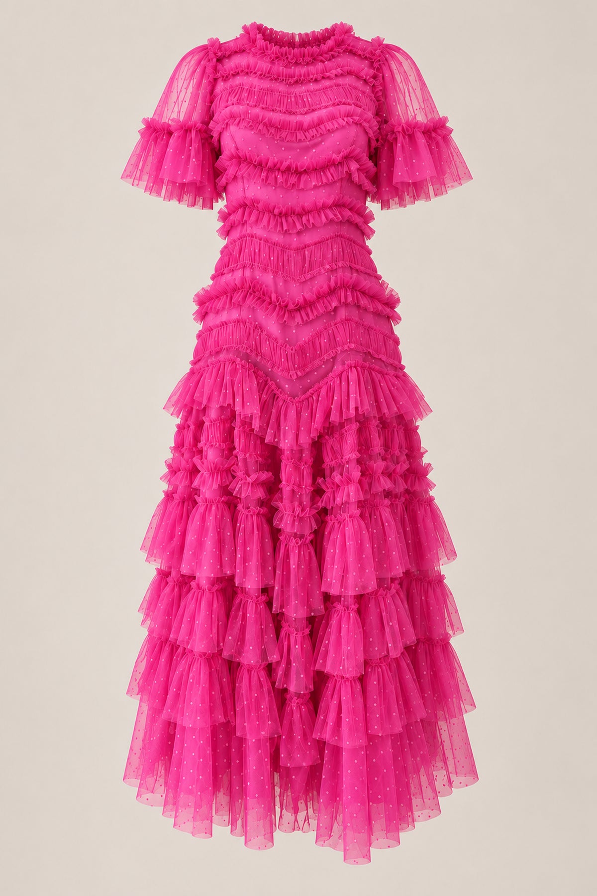 The Adriana Dress in Winter Berry by Ivy City Co is a vibrant, knee-length hot pink tulle dress featuring short sleeves, ruffled layers, and a fitted waist—perfect as a Christmas Eve outfit—displayed on a plain light background.