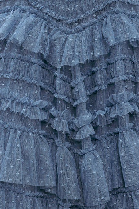 Close-up of a blue ruffled fabric with star patterns