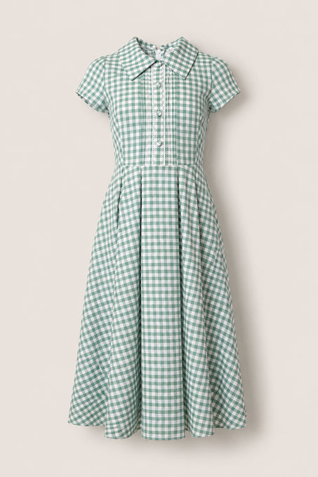 The Amber Dress in Sage Gingham by Ivy City Co is a cotton midi with short sleeves, a fitted waist, flared pleated skirt, collared neckline, and front button details.