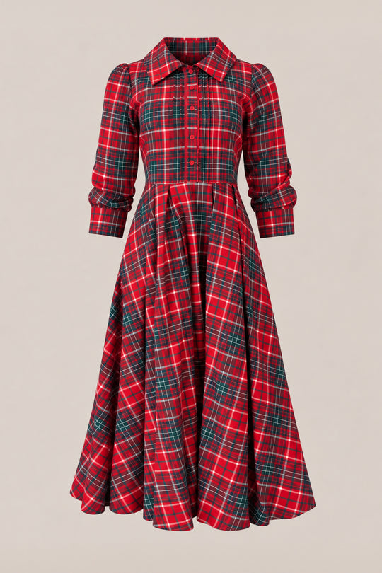 The Ivy City Co Amber 3/4 Sleeve Dress in Christmas Cheer Plaid is a girls’ dress with a fitted waist and flared skirt, featuring festive red, green, and white plaid and stylish button-up details.