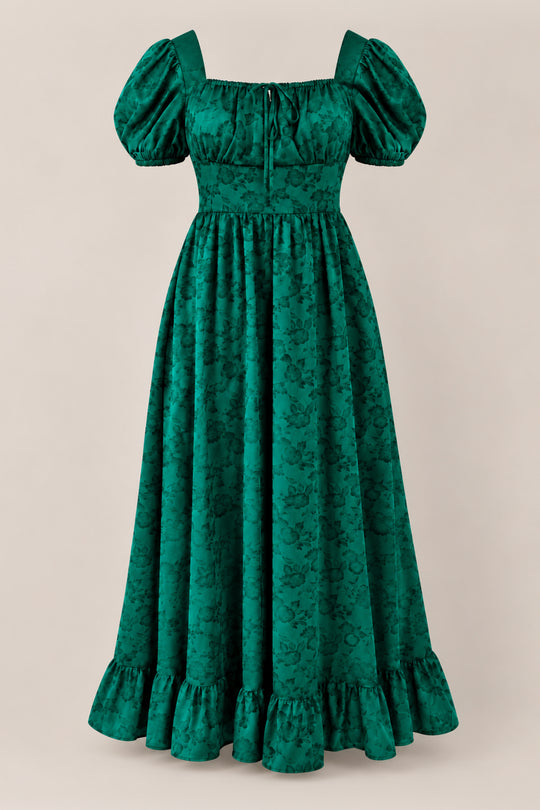 The Amira Dress in Emerald Satin by Ivy City Co is a long holiday party dress featuring puffed short sleeves, a fitted bodice, a floral jacquard pattern, and a ruffled hem, shown against a neutral background.