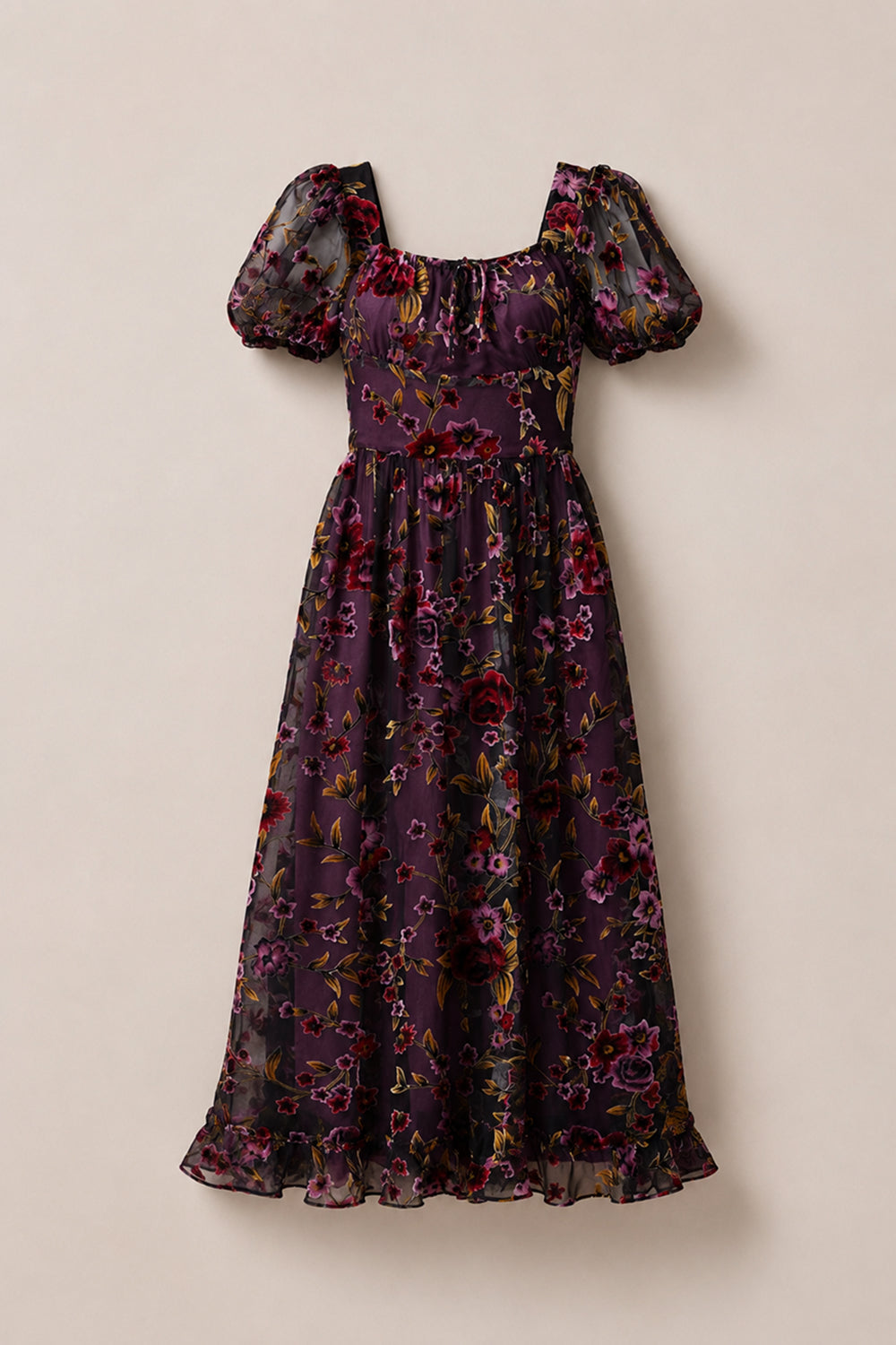 Introducing the Amira Dress in Violet Dusk Burnout by Ivy City Co—a purple, ankle-length maxi dress crafted from sheer fabric and adorned with red, pink, and yellow floral patterns. Featuring puffed short sleeves, a square neckline, pockets for added functionality, and a ruffled hem, this elegant dress effortlessly blends style and practicality.