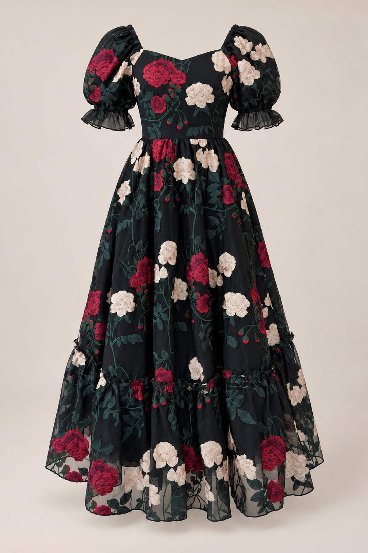 The Amora Dress in Obsidian Rose Embroidery by Ivy City Co is a long black tulle ball gown with short puffed sleeves and a voluminous skirt, adorned with striking red and white rose embroidery and green leaves for a truly romantic look.