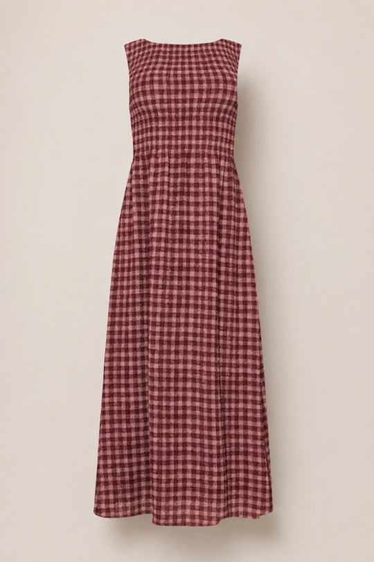 The Ana Dress in Cranberry Popcorn Plaid by Ivy City Co is a sleeveless, ankle-length dress with a maroon and pink checkered pattern, featuring a comfortable smocked bodice and a flared skirt. Displayed on a plain light background, this style is also maternity friendly.