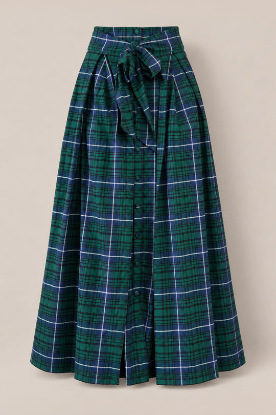 The Angela Skirt in Emerald Plaid by Ivy City Co, crafted from soft cotton with buttons down the front and a matching waist tie, is displayed on a neutral background—making it perfect for girls’ holiday portraits.