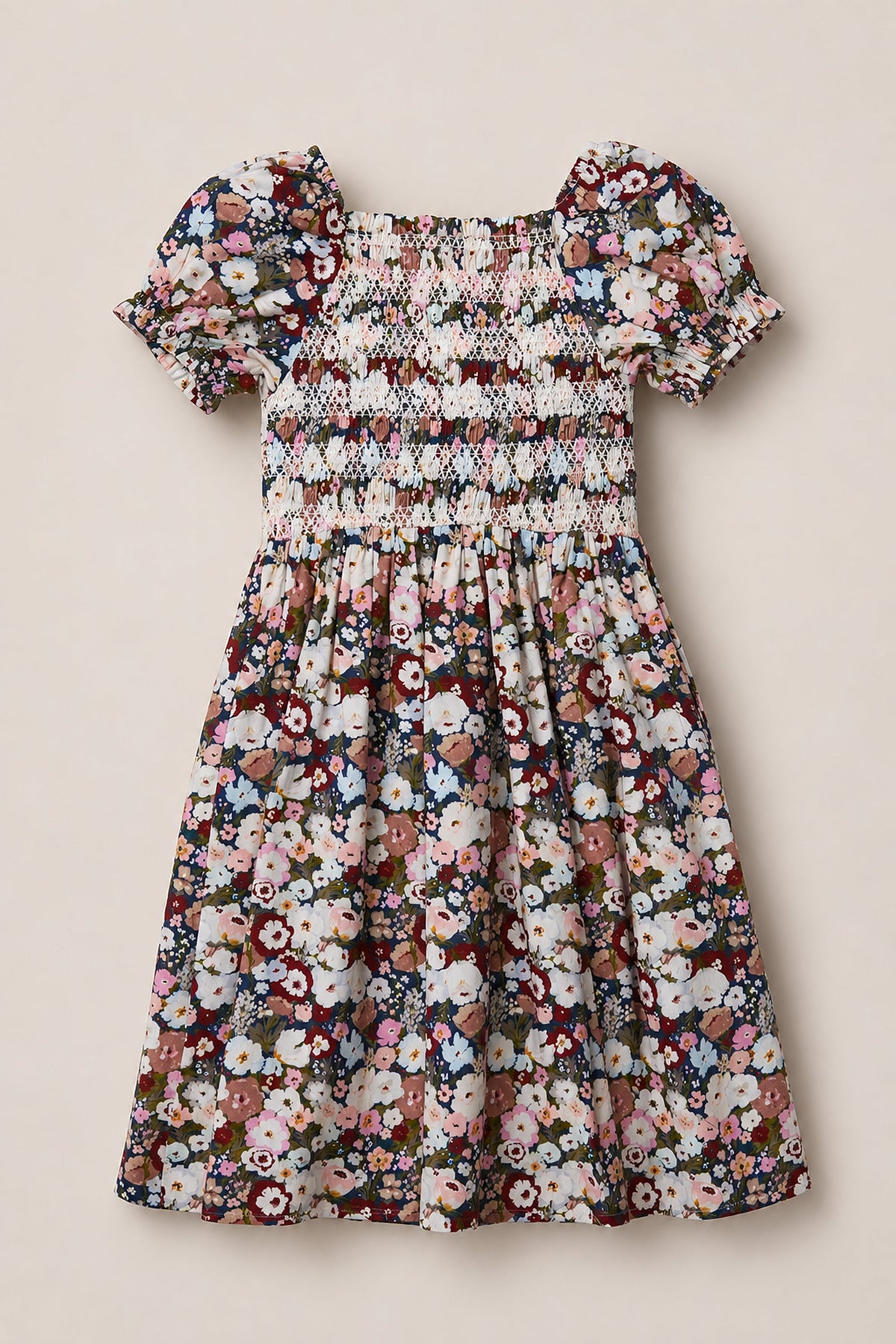 Introducing the Mini Sunday Best Dress in Midnight Garden by Ivy City Co—a delightful girls’ short-sleeve dress with a smocked bodice and adorable puff sleeves. Its colorful floral pattern on a midnight background brings playful elegance, while the gently gathered skirt ensures a beautifully flowing silhouette.