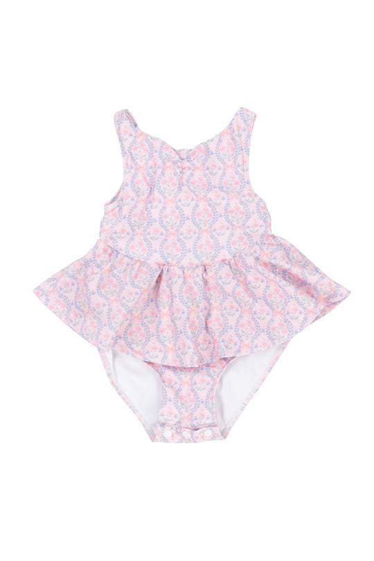 The Baby Bitsy Swim Dress in Raquel Pink Floral features a pink and white floral design with a ruffled skirt, perfect for baby girls. Displayed on a white background.