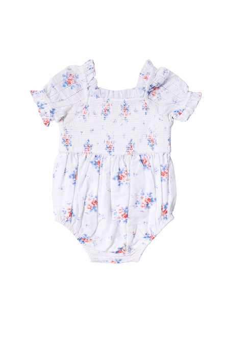 The Baby Emily Romper in Heritage Soft Ditsy Floral by Ivy City Co features a white base, pink and blue floral print, short ruffled sleeves, and smocked bodice—ideal for sweet mom and me matching moments.