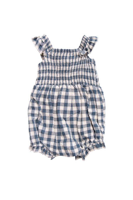 The Ivy City Co Baby Hailey Romper in Indigo Gingham—a blue and white gingham romper with ruffled straps, smocked bodice, and elastic at the chest and legs—is displayed on a white background.