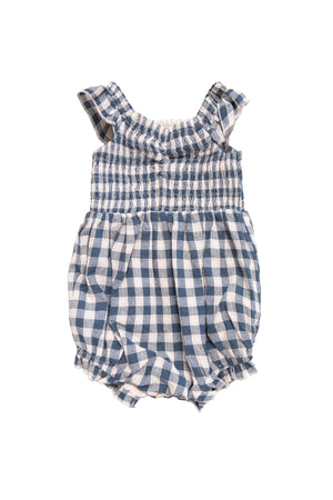 The Ivy City Co Baby Hailey Romper in Indigo Gingham features ruffled sleeves, a smocked bodice, and elastic leg openings, shown laid flat on a white background.