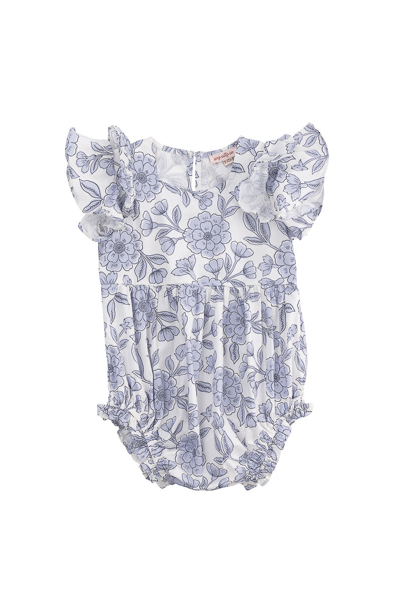 The Ivy City Co Baby Hattie Romper in Blue Floral is a cotton romper for babies, featuring flutter sleeves, a blue floral print on white, gathered leg openings, and back buttons for easy changing.