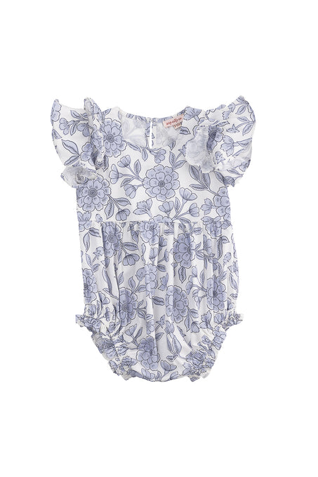 The Ivy City Co Baby Hattie Romper in Blue Floral is a cotton romper for babies, featuring flutter sleeves, a blue floral print on white, gathered leg openings, and back buttons for easy changing.