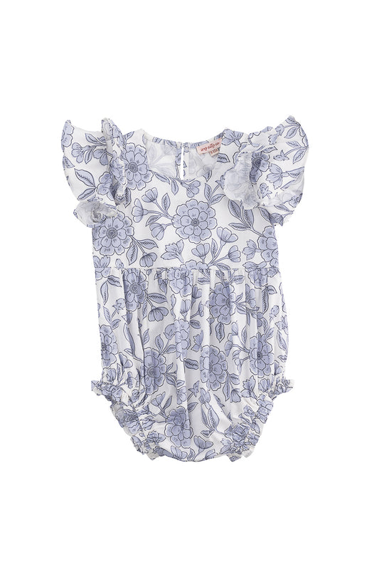 The Ivy City Co Baby Hattie Romper in Blue Floral is a cotton romper for babies, featuring flutter sleeves, a blue floral print on white, gathered leg openings, and back buttons for easy changing.
