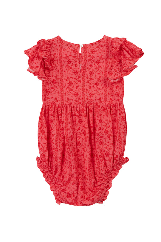 The Ivy City Co Baby Hattie Romper in Crimson Pink features a bright coral cotton fabric with floral pattern, short ruffled sleeves, back button, and elastic leg openings—adorable and comfy for your little one!.