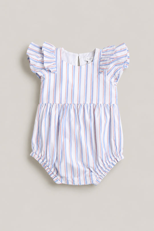 The Ivy City Co Baby Hattie Romper in Heritage Stripe features short ruffled sleeves, gathered leg openings, and blue, red, and white stripes—a perfect Fourth of July outfit for your baby. Shown laid flat on a neutral background.