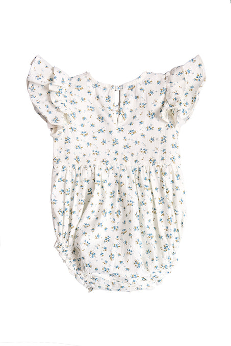 The Baby Hattie Romper in Madeline Blue by Ivy City Co is a white cotton baby romper with short ruffled sleeves, a blue and yellow floral print, gathered waist, and back button closure—perfect for special occasions.