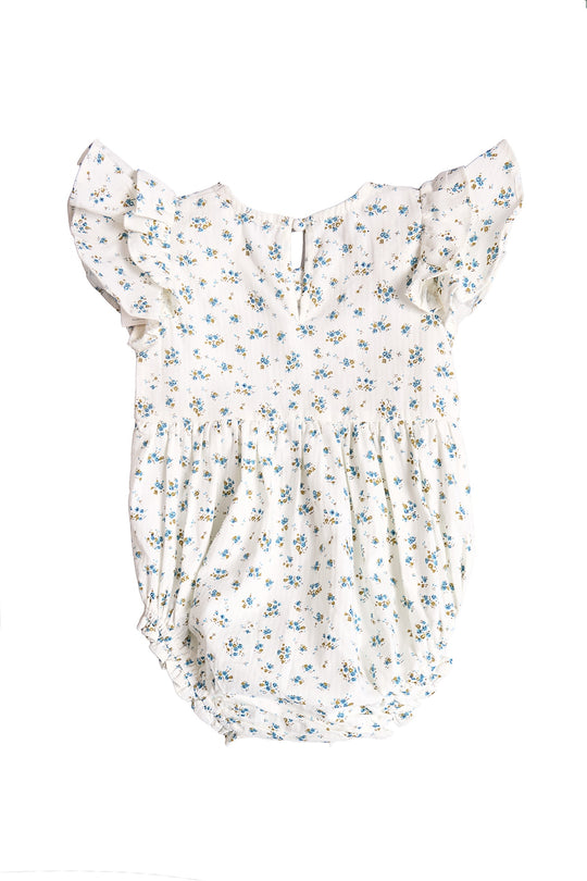 The Baby Hattie Romper in Madeline Blue by Ivy City Co is a white cotton baby romper with short ruffled sleeves, a blue and yellow floral print, gathered waist, and back button closure—perfect for special occasions.