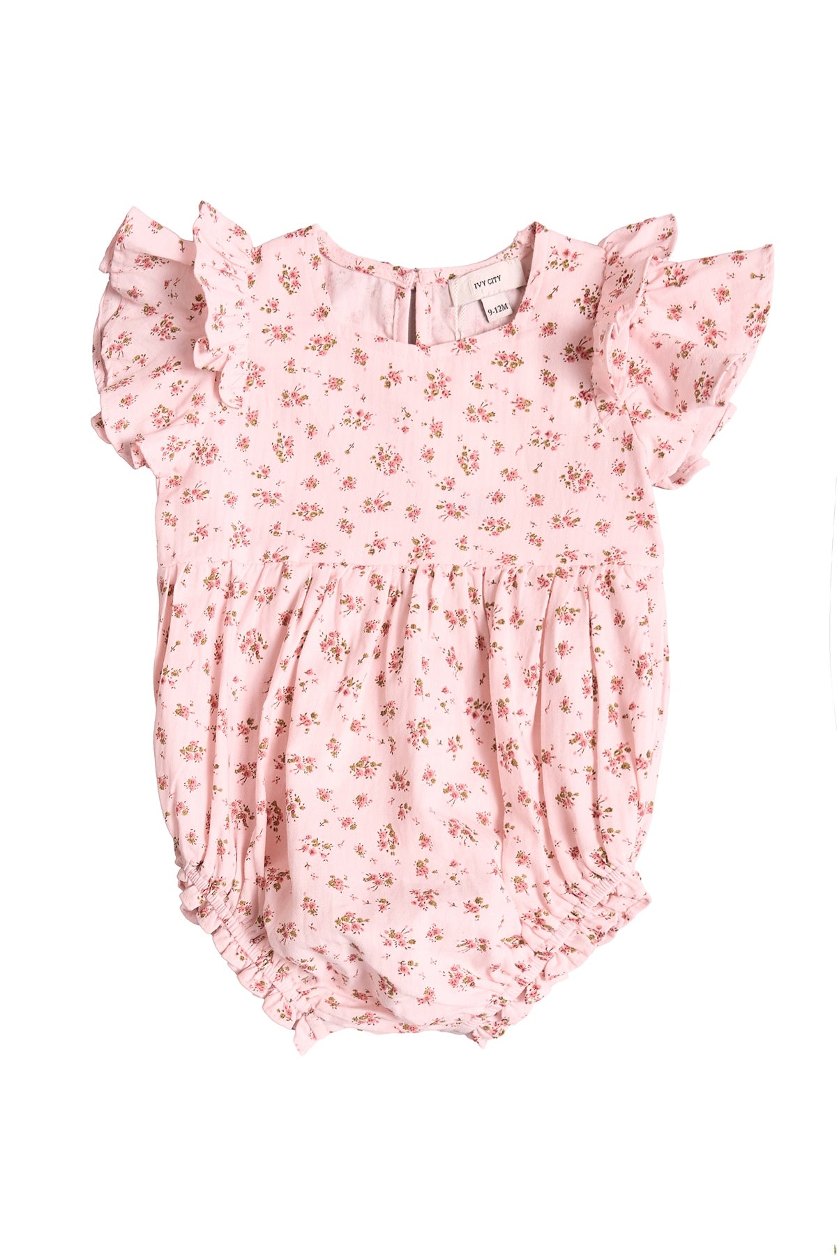 The Baby Hattie Romper in Madeline Pink by Ivy City Co features short ruffled sleeves, sweet floral print, and gathered fabric for a puffy look—perfect for a first birthday. Buttons at the back allow for easy dressing.