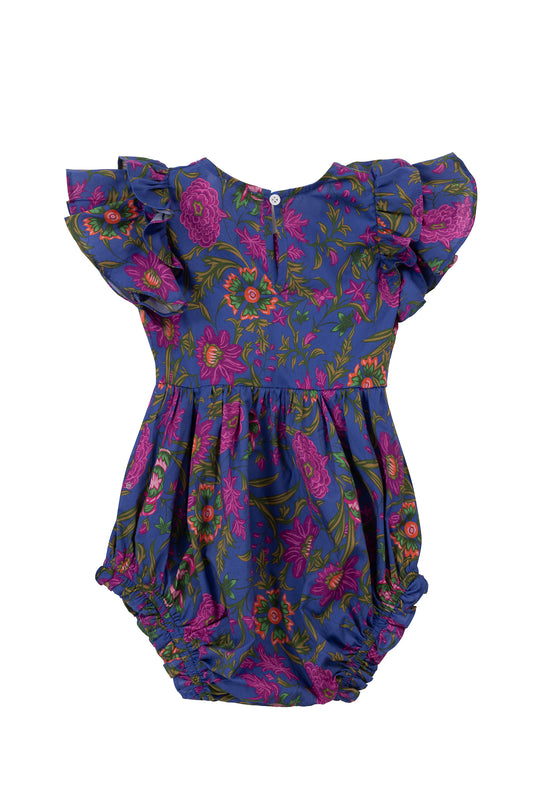 The Ivy City Co Baby Hattie Romper in Blue Multicolor Floral features flutter sleeves, a vibrant pink, red, and green floral print on deep blue, back buttons, and ruffled leg openings.