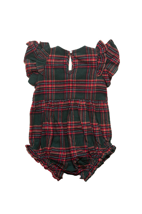Plaid baby romper with ruffled details on a white background