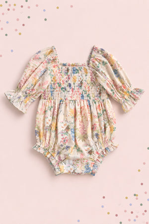 The Ivy City Co Baby Madeline Romper in Cordelia Floral features long puffed sleeves, ruffled cuffs, and a smocked bodice on pale pink with pastel confetti dots—perfect for adorable mommy-and-me moments.