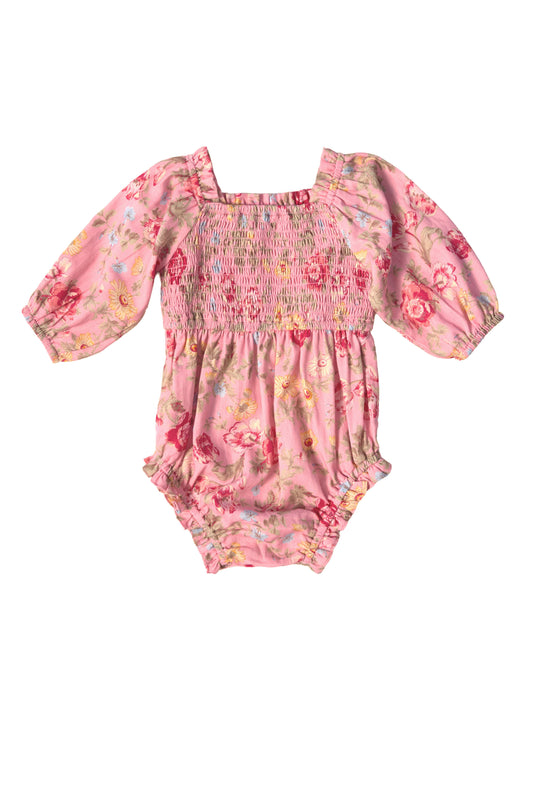 The Ivy City Co Baby Madeline Romper in Pink Vintage Poppies features long sleeves, a square neckline, smocked bodice, elastic wrists and legs, and soft fabric with a colorful floral pattern for a sweet look.