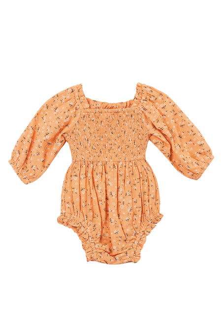 The Baby Madeline Romper in Sorbet by Ivy City Co. features a peach floral design, smocked bodice, long puff sleeves with elastic cuffs and leg openings, plus a gathered skirt for comfort and charm.