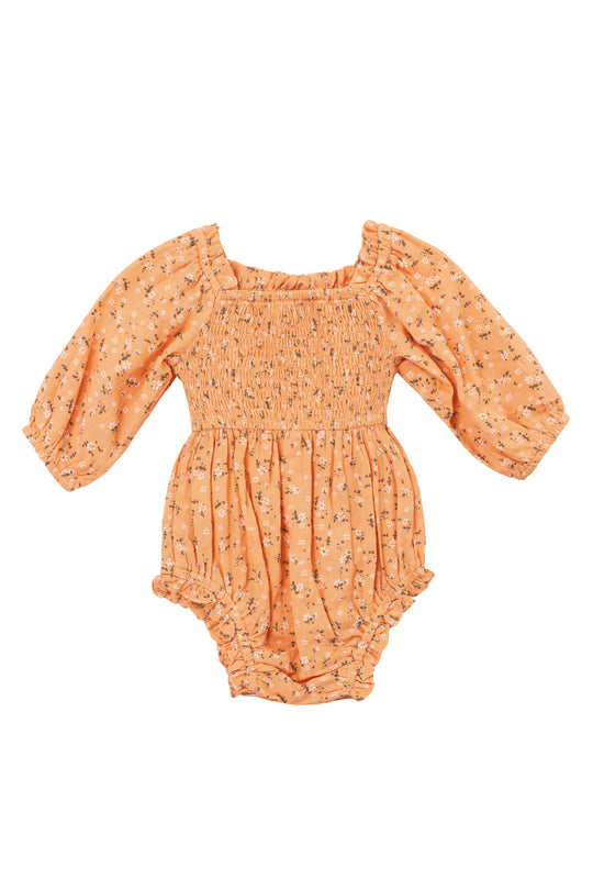 The Baby Madeline Romper in Sorbet by Ivy City Co. features a peach floral design, smocked bodice, long puff sleeves with elastic cuffs and leg openings, plus a gathered skirt for comfort and charm.