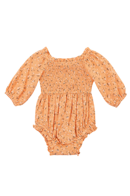 The Ivy City Co. Baby Madeline Romper in Sorbet features a peach floral print, long puff sleeves, smocked bodice, elastic waist and cuffs, plus ruffled leg openings for a charming baby look.