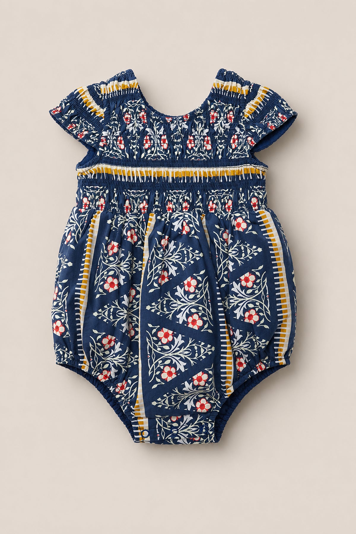 Discover the Baby Marlow Romper in Navy Fleur by Ivy City Co—a delightful short-sleeve cotton romper featuring navy blue, white, yellow, and red floral patterns. This charming piece showcases a classic round neckline and gathered details at both the neckline and waist for added comfort and style.