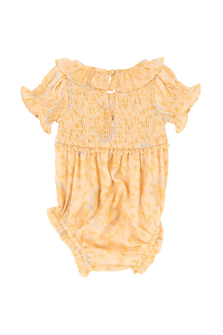 The Baby Meg Romper in Yellow by Ivy City Co features ruffled short sleeves, a smocked bodice, ruffled collar, gathered legs, and a subtle floral pattern—ideal for your little one’s first paisley-inspired romper. Displayed on a white background.