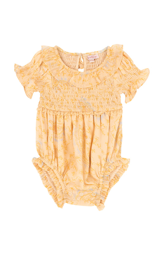 The Ivy City Co Baby Meg Romper in Yellow features short ruffled sleeves, a smocked bodice, ruffled collar, subtle floral print, elastic leg openings, and snap closures. Shown laid flat on a white background.
