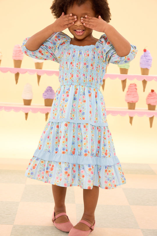 Child wearing a floral dress with ice cream cone background