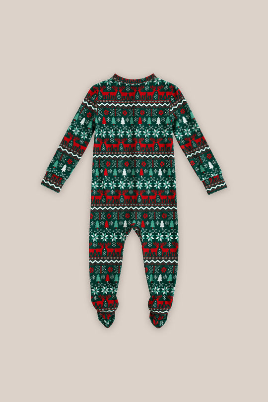 The Ivy City Co Baby So Soft Onesie in Alpine Noel features long sleeves, covered feet, and a festive red, black, and green reindeer and snowflake pattern on soft cotton-modal knit.