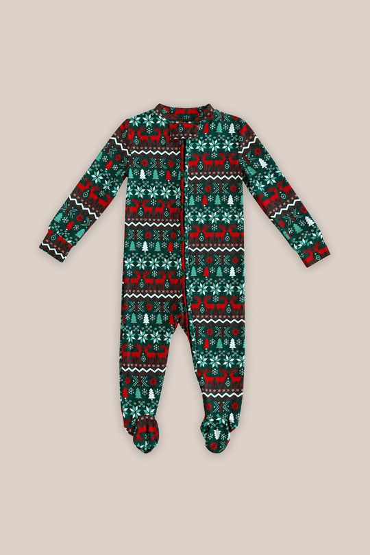 The Baby So Soft Onesie in Alpine Noel by Ivy City Co is a long-sleeved, footed baby Christmas onesie in soft cotton-modal knit with a festive red, green, black, and white pattern on beige.