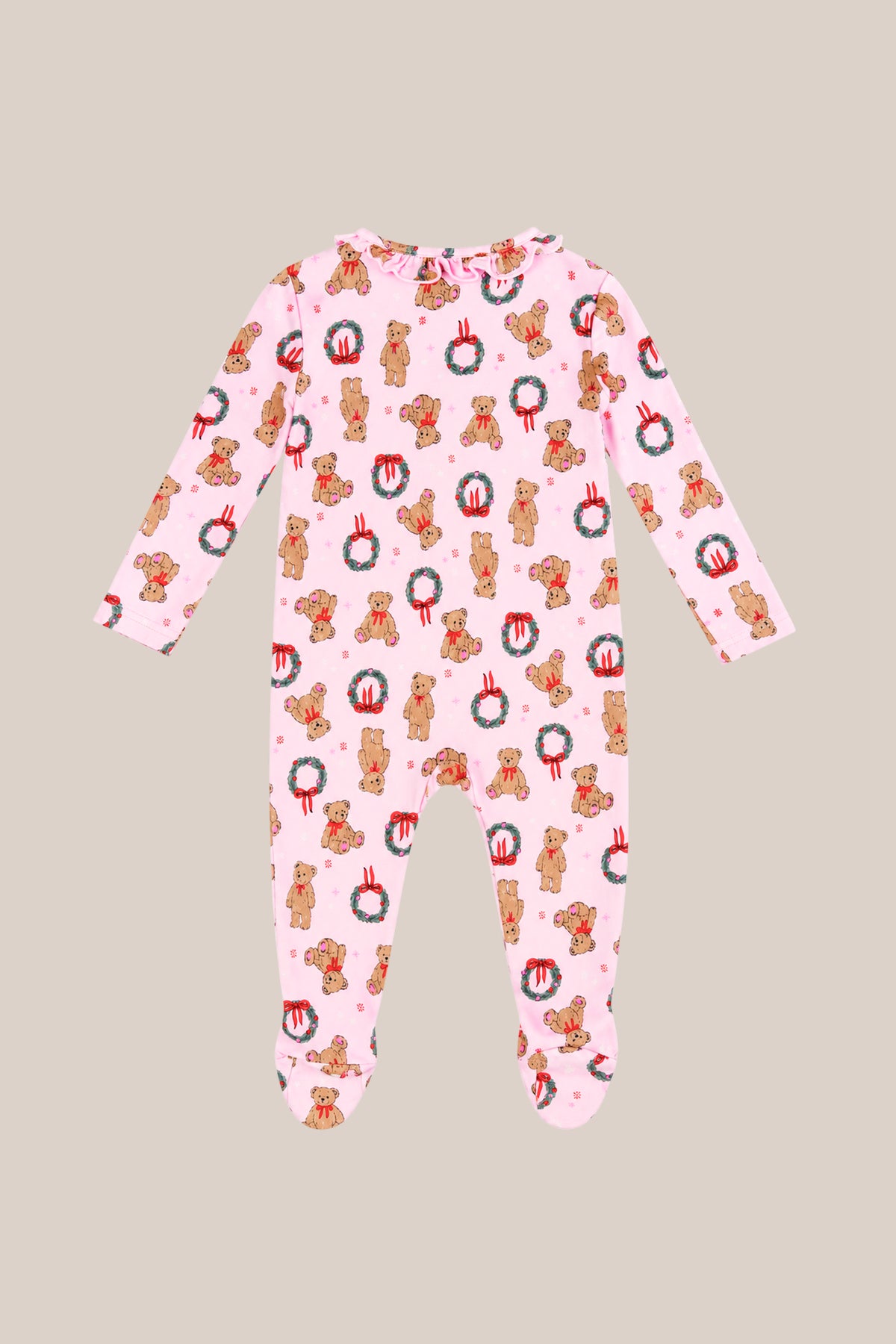 The Baby So Soft Onesie in Teddy Bear Wreaths by Ivy City Co is made from soft cotton-modal knit with a teddy bear and wreath print. These cozy, long-sleeve holiday pajamas are shown laid flat on a beige background.