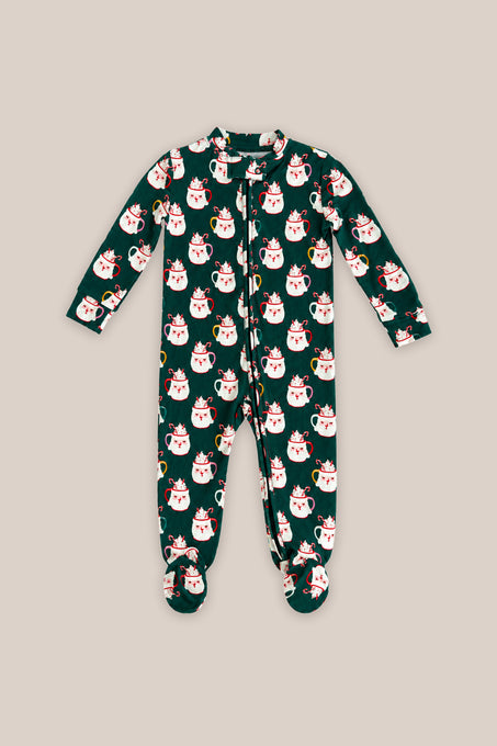 The Baby So Soft Onesie in Very Merry Santa by Ivy City Co features a dark green cotton-modal knit with white cat prints in red Santa hats, a front zipper, and long sleeves, shown on a beige background.